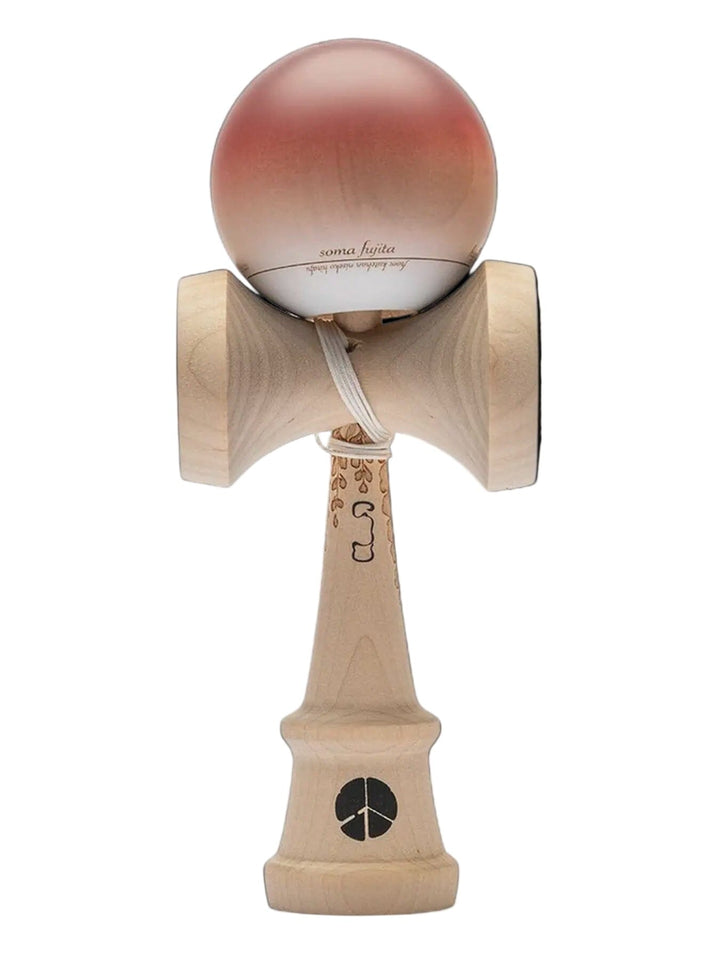 Wooden kendama toy with pink ball on a black background